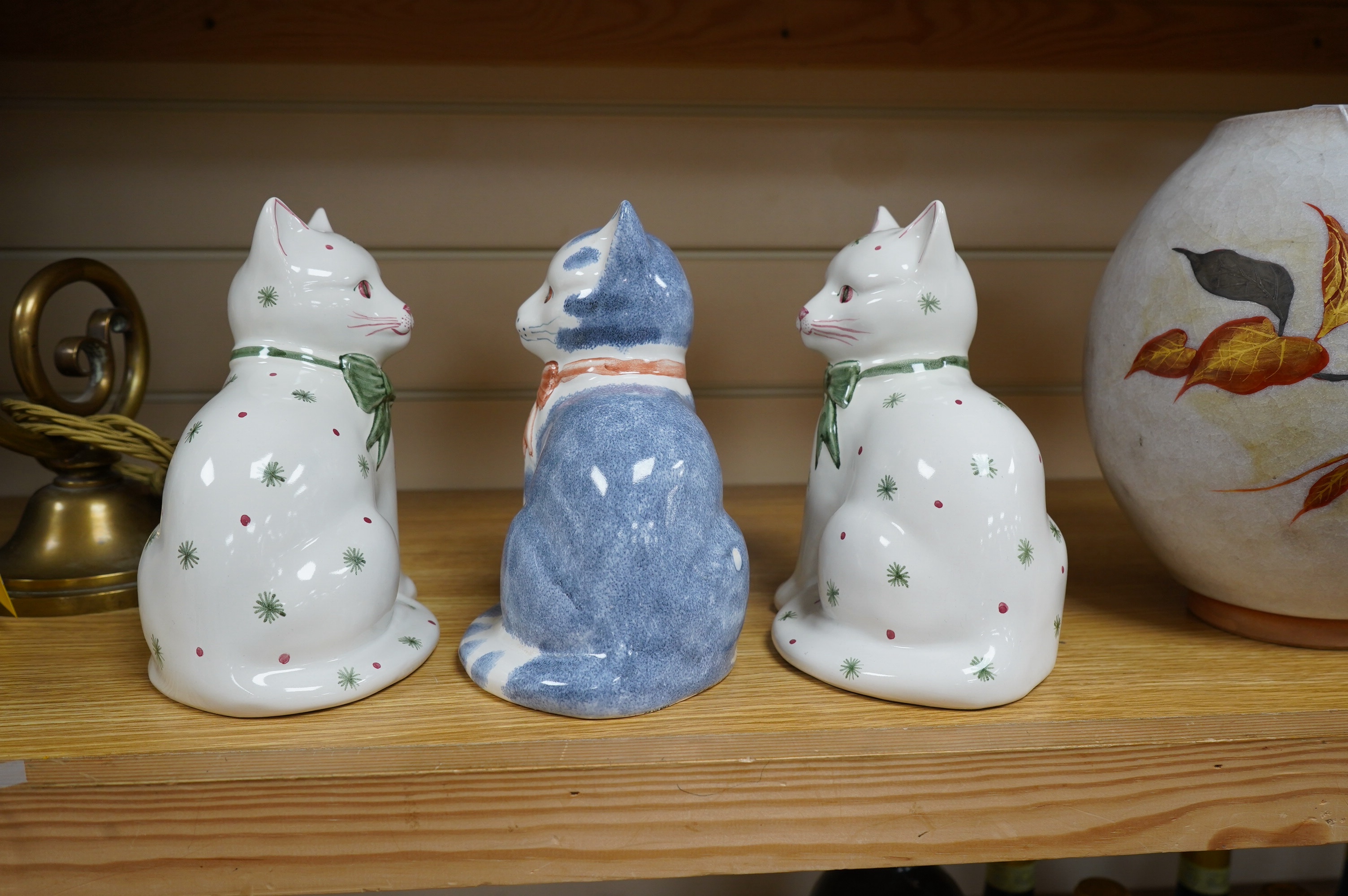 A pair of Rye pottery seated cats, and another, largest 19.5cm high. Condition - good